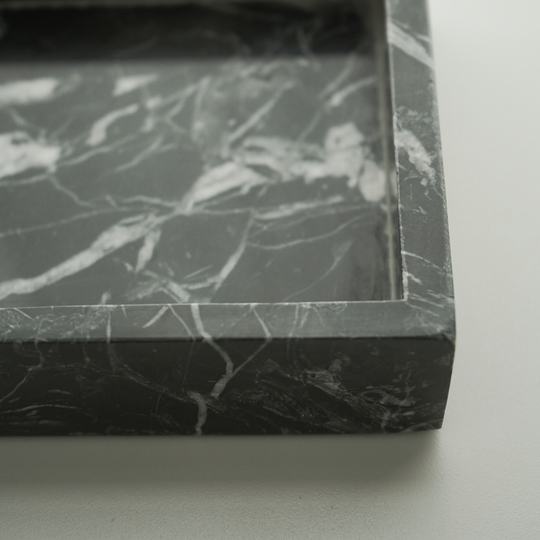 A sleek black tray with a smooth matte finish, perfect for serving or organizing items. Its minimalist design and sturdy construction make it both functional and stylish. 3