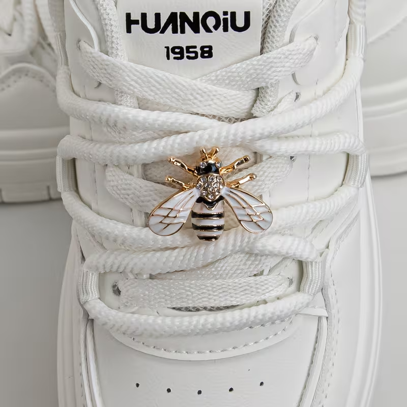 A Pair of Detachable Cute Little Bee-Style White-Winged Shoes with Glittery Decorations on the Laces and the Buckle.