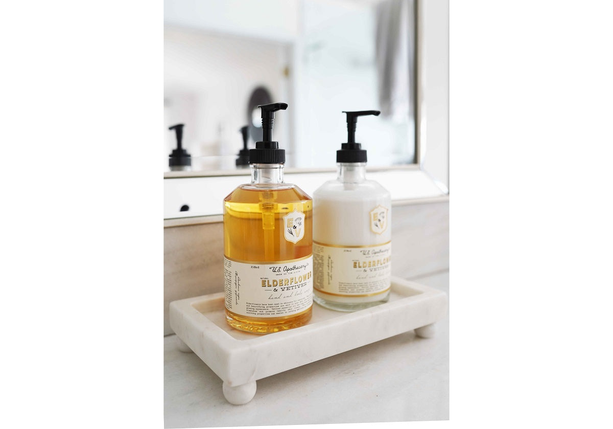 A Petite Marble Footed Tray is a chic and compact accent piece, crafted from natural marble with unique veining.